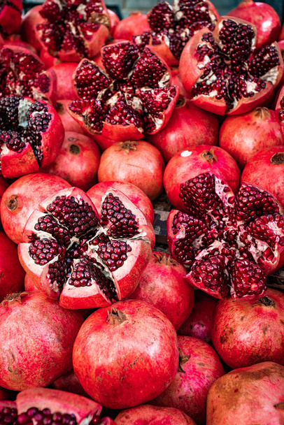 Red pomegranate fruit at street market. Group of pomegranates - Photo, image