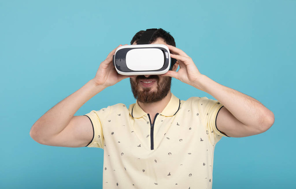 Young bearded man using virtual reality headset. VR, future, gadgets, technology concept. - Valokuva, kuva