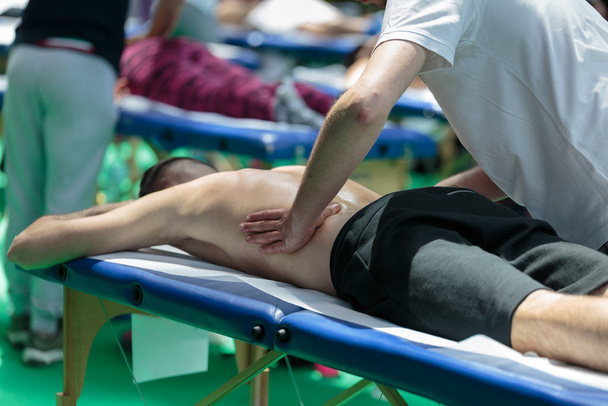 Athlete's Back Professional Massage on Bed after Sport Fitness Activity - Photo, Image