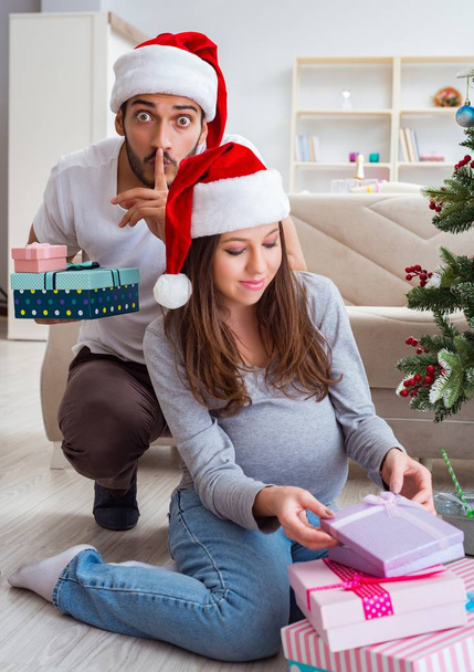 Young family expecting child baby celebrating christmas - Photo, Image