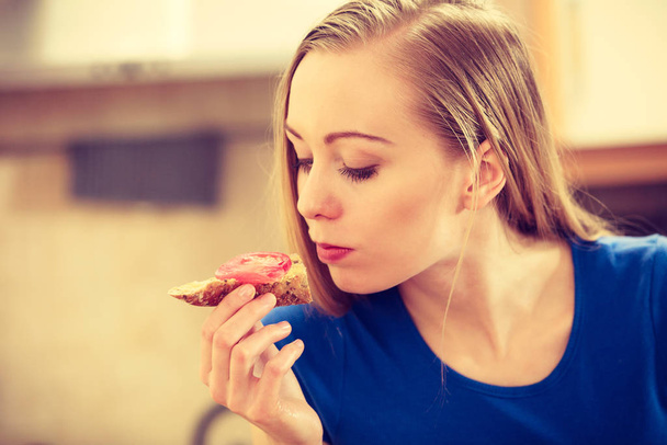 Woman having healthy breakfast eating sandwich - 写真・画像