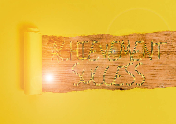 Conceptual hand writing showing Achievement Success. Concept meaning status of having achieved and accomplished an aim Cardboard which is torn placed above a wooden classic table - Photo, Image