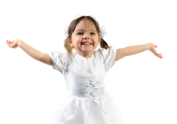 Happy little girl posing in white dress - 写真・画像