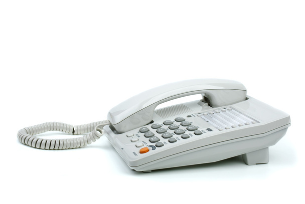 Teléfono de oficina blanco con auricular en gancho
 - Foto, Imagen