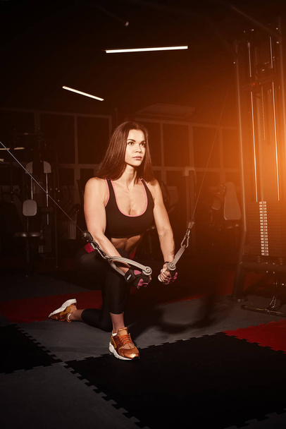 Strong Sporty girl in gym doing exercises - Foto, Imagen
