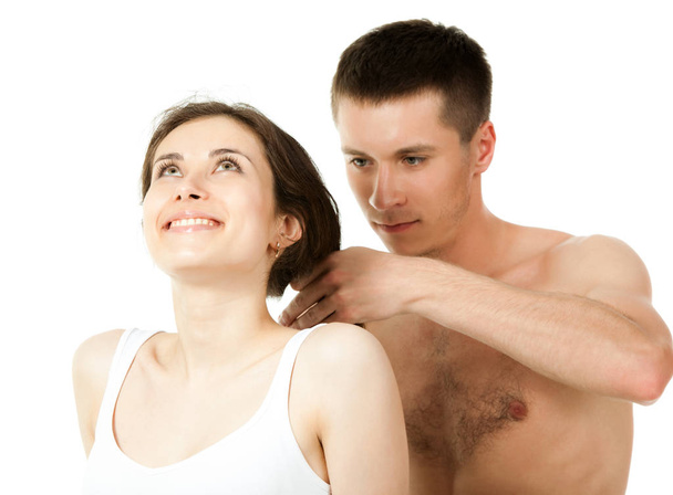 Guy sitting next to girl and combing her hair - Fotó, kép
