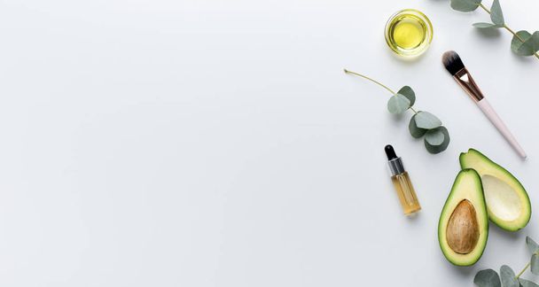 Ingrediënten voor thuis spa bovenaanzicht: honing, avocado, etherische olie - Foto, afbeelding