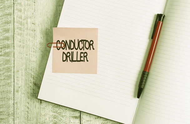 Word writing text Conductor Driller. Business concept for means of conveying the upflowing drilling fluid Thick pages notebook stationary placed above classic look wooden backdrop. - Photo, Image
