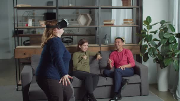 Deaf people laughing at friend playing in vr glasses - Video