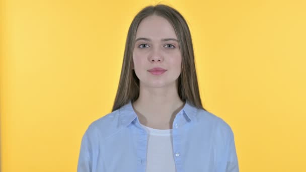 Casual Young Woman Celebrating Success, Yellow Background - Кадри, відео