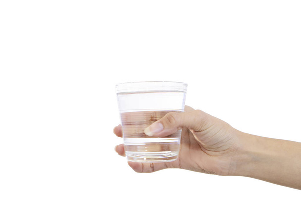 Beautiful female hand holding a glass of water - Фото, изображение