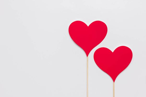 Stock photo of two red paper hearts on a white background - Photo, Image