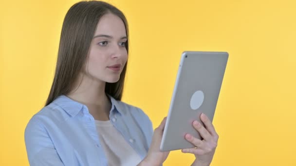 Young Woman using Tablet, Yellow Background - Video