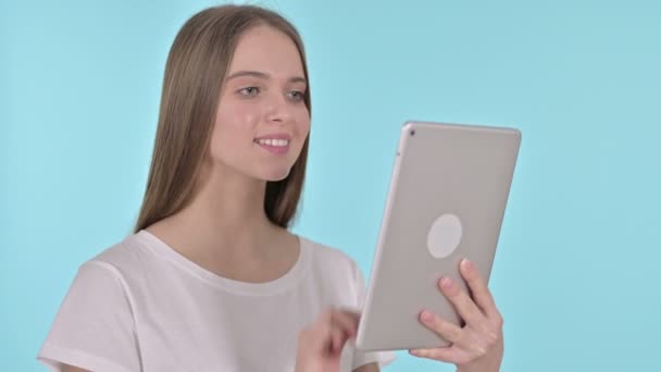 Video Chat on Tablet by Young Woman, Blue Background - Кадри, відео