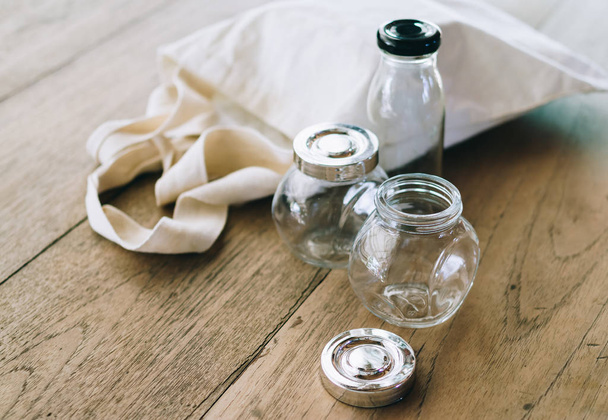 Cloth bag and glass jars on wooden table, no plastic packages, zero waste concept - Photo, Image