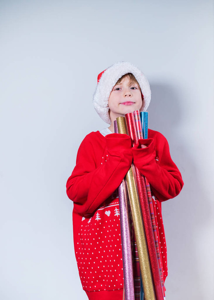 Charming boy wearing Santa's Hat in red sweater - Zdjęcie, obraz