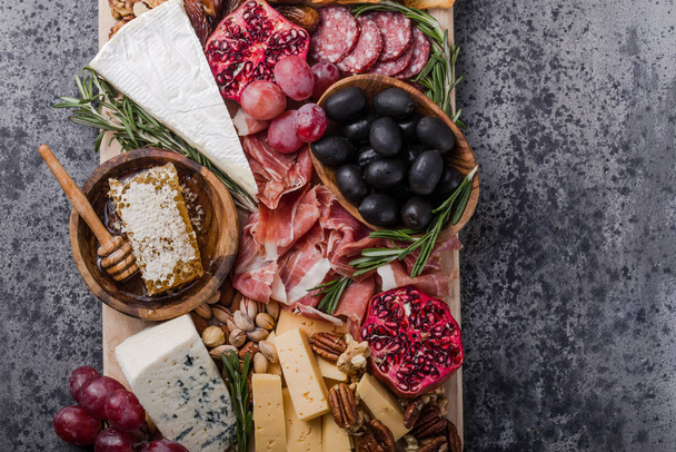Traditional italian antipasto plate. Assorted cheeses on wooden  - Fotó, kép