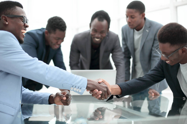 reliable handshake of business partners over the desktop. - Photo, Image