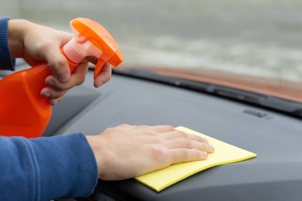 Hand cleaning dashboard with microfiber cloth. Car care concept. Car wash - Foto, imagen
