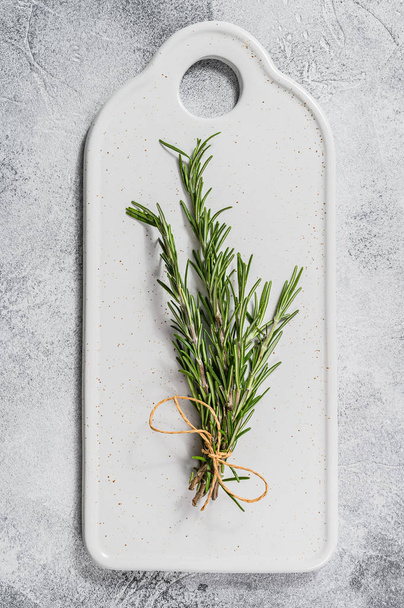 A sprig of rosemary on a white background. Space for text. Spices for meat - Fotografie, Obrázek