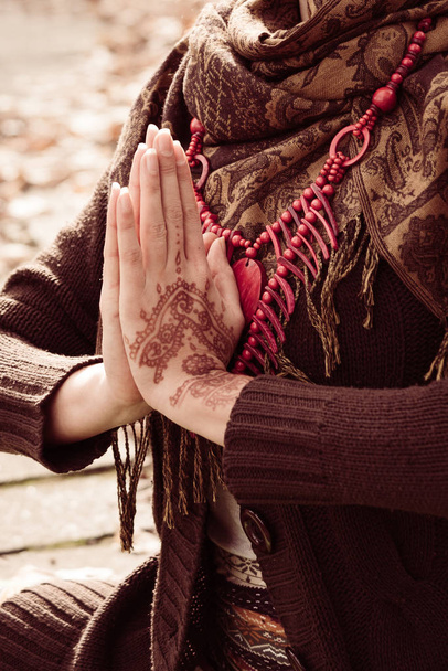 close-up van yoga vrouw handen in namaste gebaar met henna verdrinken - Foto, afbeelding