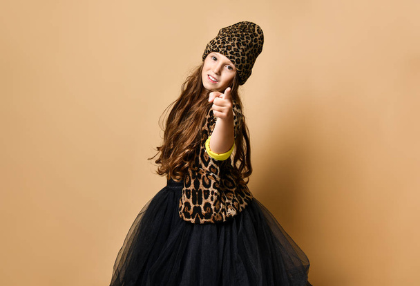 Young plus size girl model in stylish leopard colored casual clothing and black skirt standing and pointing at camera - Φωτογραφία, εικόνα