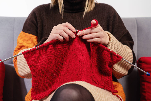Handwork concept, young woman is knitting a needlework - Zdjęcie, obraz