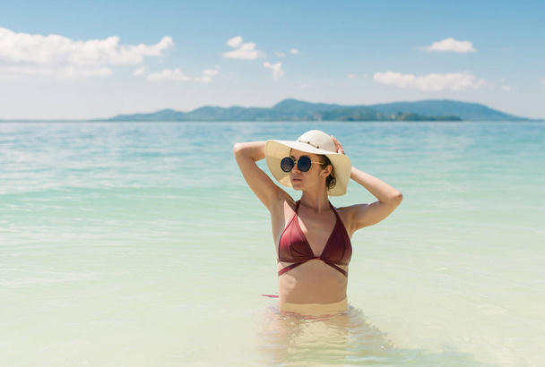 Portrait of tan model looking at seaside outdoors - Фото, изображение