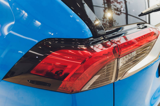 Rear light of a modern car close-up, white body. blue body - Foto, afbeelding
