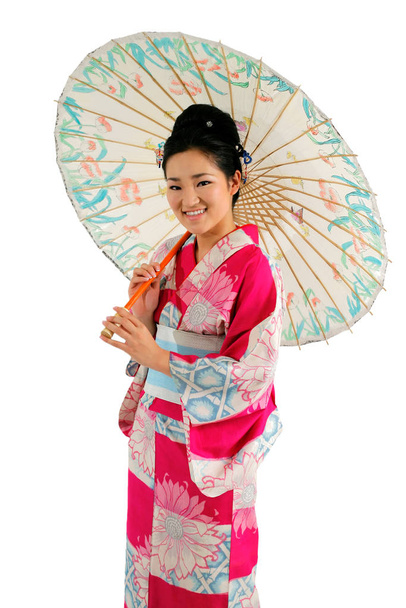 Asian girl in a traditional kimono with umbrella isolated on white - Foto, afbeelding