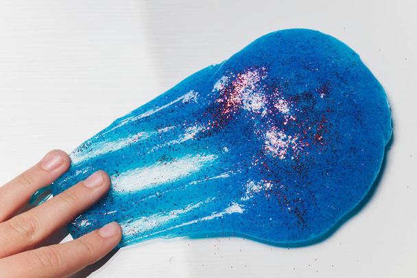 Kid Playing Hand Made Toy Called Slime Alien drool Shell mussel. - 写真・画像