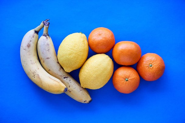 Various whole fruits on a blue background                                                        - Photo, Image