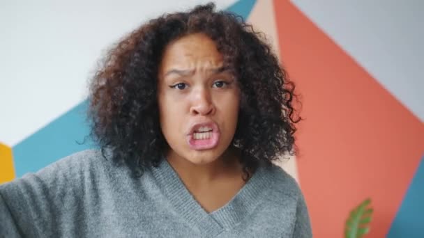 Portrait of mad Afro-American woman yelling gesturing looking at camera with rage - Filmati, video
