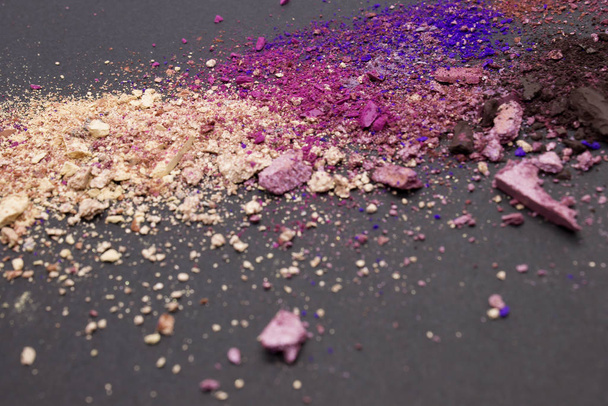 This is a photograph of nude,brown,blue,pink and purple matte and shimmery powder Eyeshadow on a Black background - Photo, Image