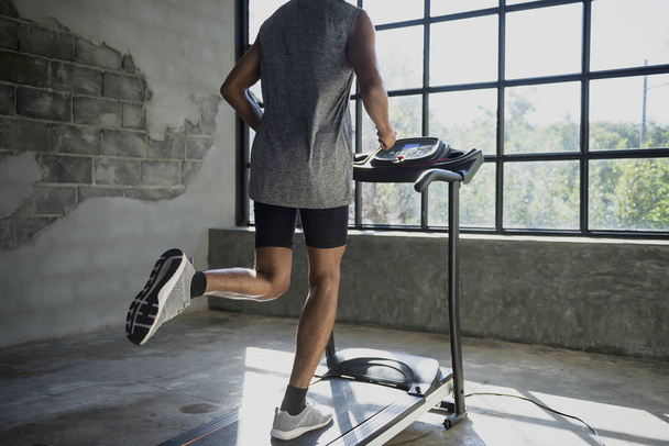 A man walking and exercising on a treadmill. - Photo, Image