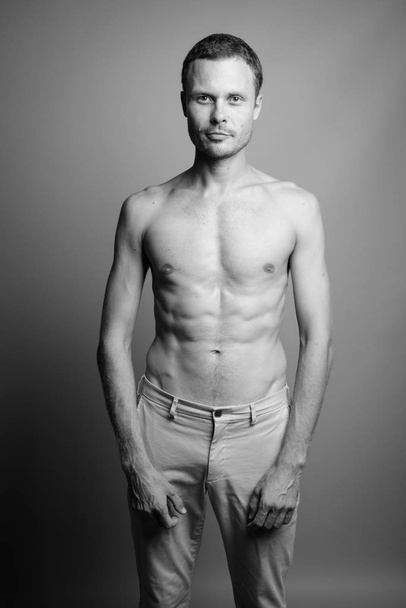 Portrait of handsome man shirtless against gray background - Φωτογραφία, εικόνα