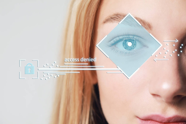 Female hacker with iris scanning, closeup. Concept of digital crime - Фото, изображение