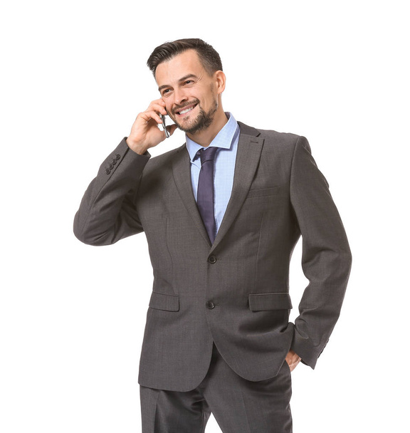 Portrait of handsome businessman talking by mobile phone on white background - Photo, image