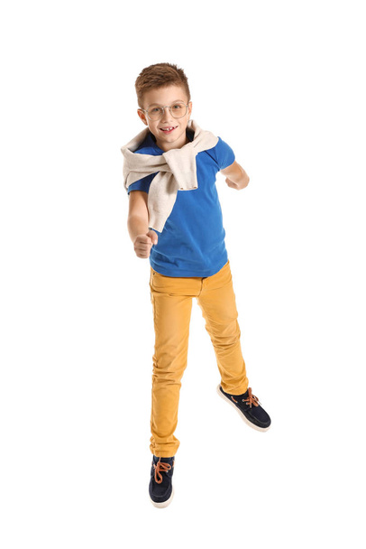 Jumping fashionable boy on white background - Foto, afbeelding