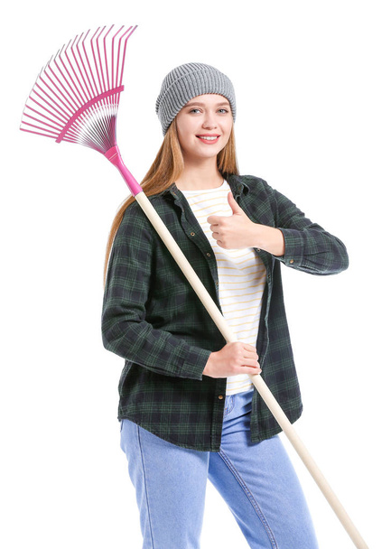 Woman with rake for autumn leaves clean-up on white background - Foto, immagini