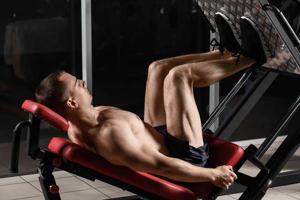 Sporty muscular man training in gym - Fotoğraf, Görsel