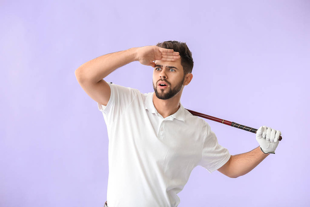 Handsome male golfer on color background - Photo, Image