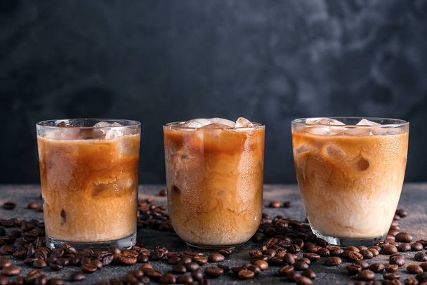 Glasses of tasty cold coffee on dark background - Valokuva, kuva