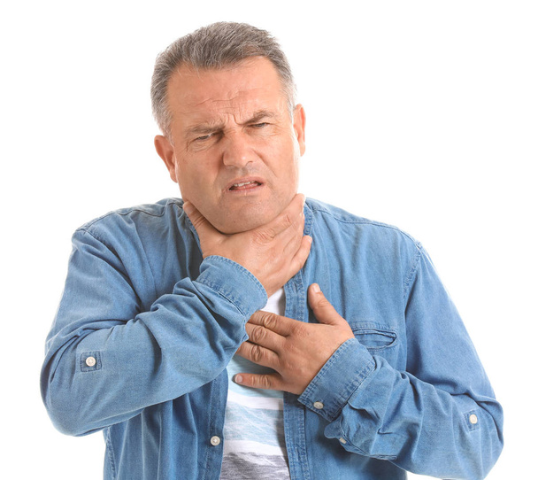 Mature man with sore throat on white background - Valokuva, kuva