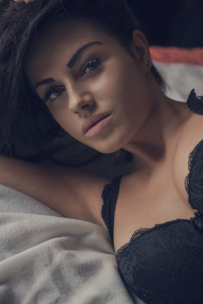 young pretty woman lying in black underwear - Photo, Image