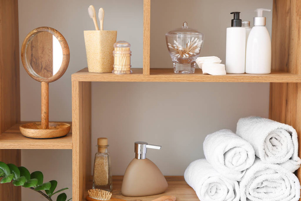 Body care cosmetics with accessories on shelves in bathroom - Foto, Bild