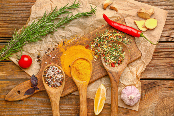 Many different spices on wooden background - Valokuva, kuva
