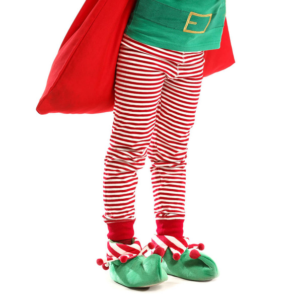 Little girl in costume of elf and with Santa Claus bag on white background - Photo, Image