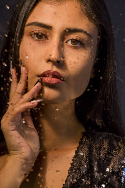 magnificent young brunette woman portrait outside the wet window - 写真・画像