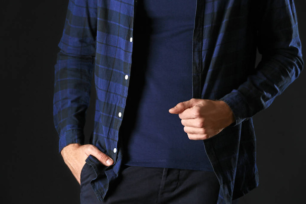Man in stylish blue clothes on dark background - Фото, зображення
